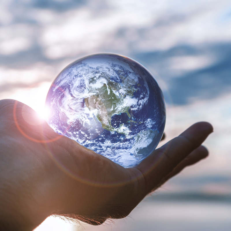 Hand holding a glass globe Square muted